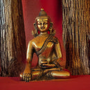 buddha statue in red fabric